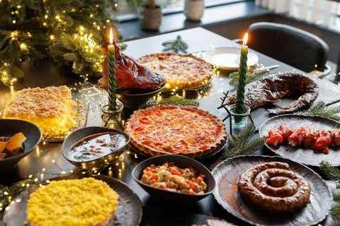 Festive table setting with Christmas decorations and burning candles in the.. Stock Photos