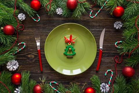 Festive table setting with cutlery and Christmas decorations on wooden table. Stock Photos