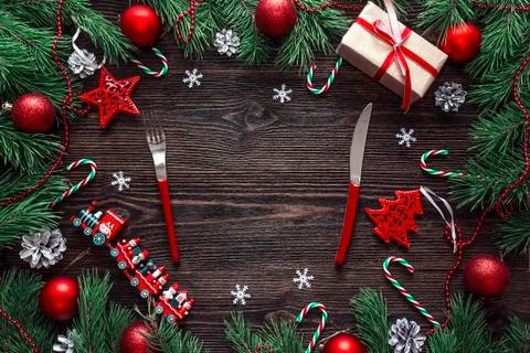 Festive table setting with cutlery and Christmas decorations on wooden table. Stock Photos