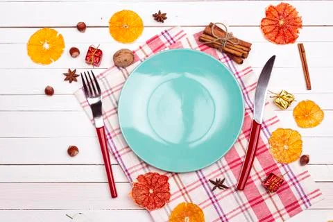 Festive table setting with cutlery, dried oranges and spices on white wooden  Stock Photos