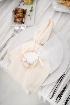 Festive table setting with decorative napkin, guest favor and elegant cutlery Stock Photos