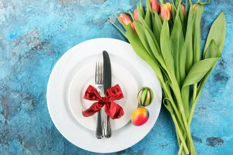 Festive table setting for Easter with fork, knife and tulip Stock Photos