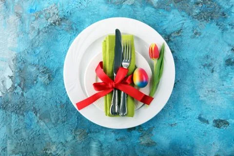 Festive table setting for Easter with fork, knife and tulip Stock Photos