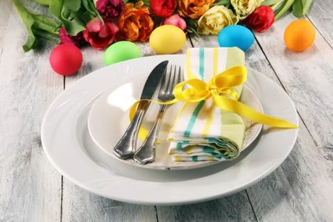 Festive table setting for Easter with fork, knife and tulip Stock Photos