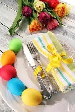 Festive table setting for Easter with fork, knife and tulip Stock Photos