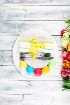 Festive table setting for Easter with fork, knife and tulip Stock Photos