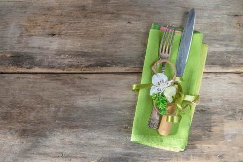 Festive table setting for easter holiday. Antique fork and knife, green napki Stock Photos