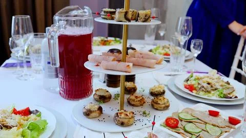 Festive table setting featuring diverse plates with salads, appetizers, cold Foto stock