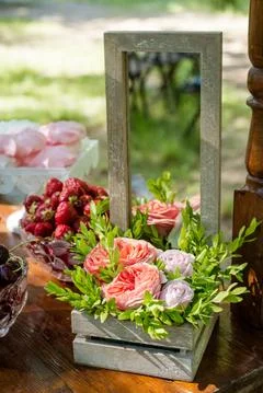 Festive table setting with flowers, fruit and marshmallows. Wedding decor. Stock Photos