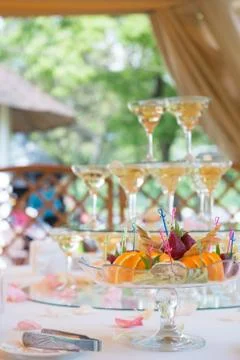 Festive table setting with fruit and wineglasses with champagne. Wedding deco Stock Photos