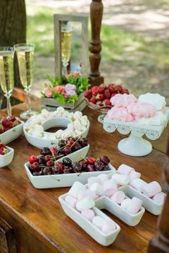 Festive table setting with fruit and marshmallows. Wedding decor. Stock Photos