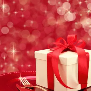 Festive table setting with gift box on a plate Stock Photos