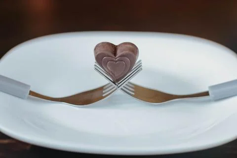 Festive table setting. Heart on a fork close-up. Holiday concept. Valentine's 库存照片
