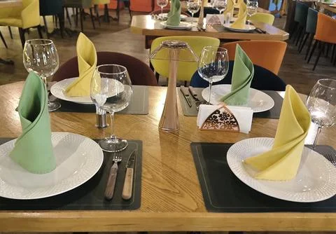 Festive table setting in a modern restaurant with vibrant decor Stock Photos