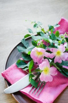 Festive Table setting with pink flowers. Stock Photos