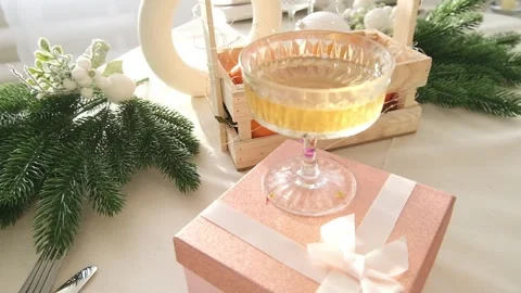 Festive table setting with a pink gift box in a plate on the table. Banner. Side Stock Footage 224851490