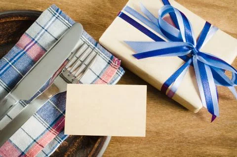 Festive Table Setting with Postcard and Present. Stock Photos