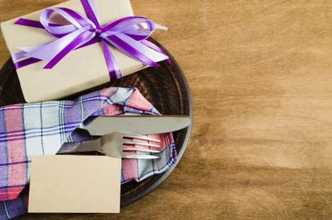 Festive Table Setting with Postcard and Present. Stock Photos