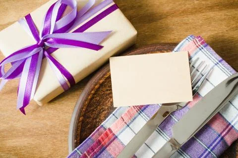 Festive Table Setting with Postcard and Present. Stock Photos