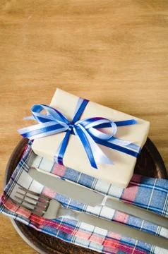Festive Table Setting with Present. Stock Photos