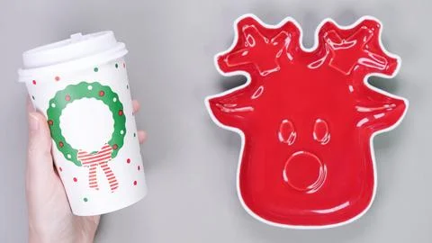 Festive table setting with red plate in Christmas raindeer shape and dispoz.. Stock Photos