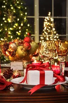 Festive table setting with red ribboned gift Stock Photos