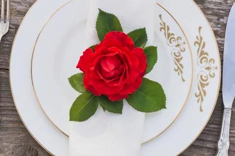 Festive table setting with red rose flower. Stock Photos