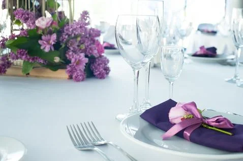 Festive table setting in the restaurant with flowers. Wedding decor. Stock Photos
