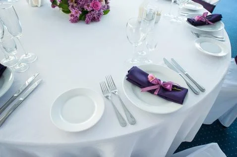 Festive table setting in the restaurant with flowers. Wedding decor. Stock Photos