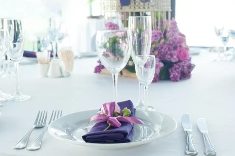 Festive table setting in the restaurant with flowers. Wedding decor. Stock Photos
