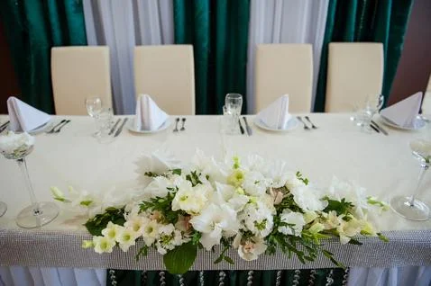 Festive table setting in the restaurant with flowers. Wedding decor. Stock Photos