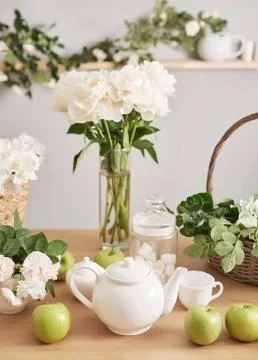 Festive table setting. Tea set and flowers on table. Bouquet of roses and peo Stock Photos