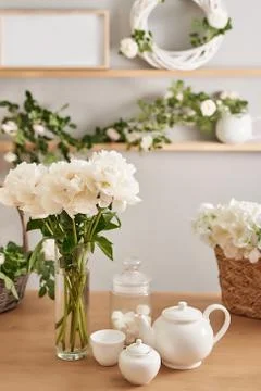 Festive table setting. Tea set and flowers on table. Bouquet of roses and peo Stock Photos