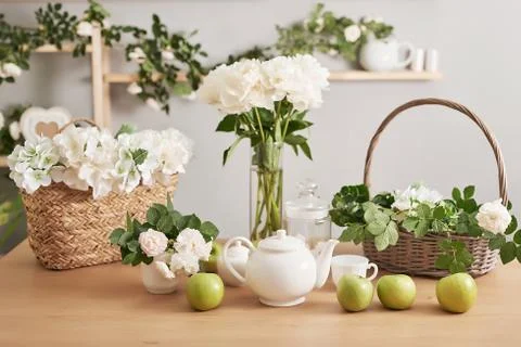 Festive table setting. Tea set and flowers on table. Bouquet of roses and peo Stock Photos