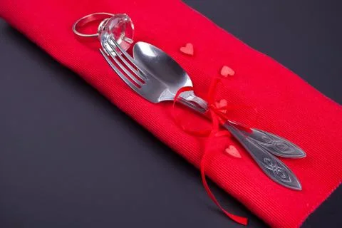 Festive table setting for Valentines Day with red napkin and cutlery Stock Photos