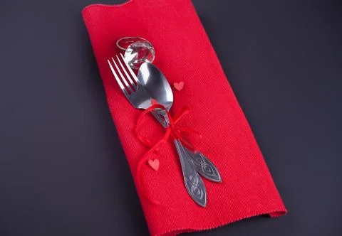 Festive table setting for Valentines Day with red napkin and cutlery Stock Photos