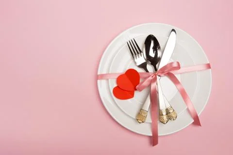 Festive table setting for Valentine's Day with fork, knife,  hearts on a red  Stock Photos