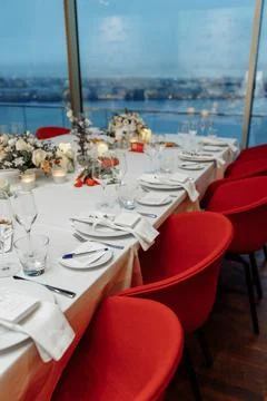 Festive table setting for a wedding or banquet with a panoramic view of the city Stock Photos