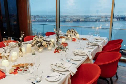 Festive table setting for a wedding or banquet with a panoramic view of the city Stock Photos