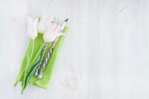 Festive table setting with white tulips. Space for text, flat lay Stock Photos