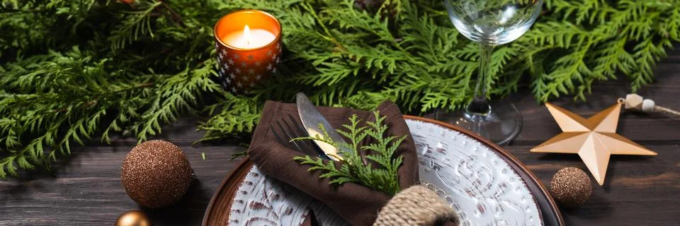 Festive table setting with winter decor. Christmas or New Year holiday banner. Stock Photos