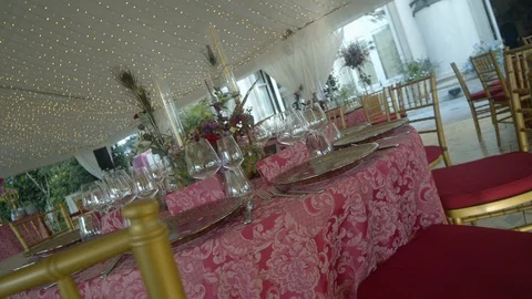 Festive table with a tablecloth on which are beautiful plates, flowers, glasses Stock Footage 128762045