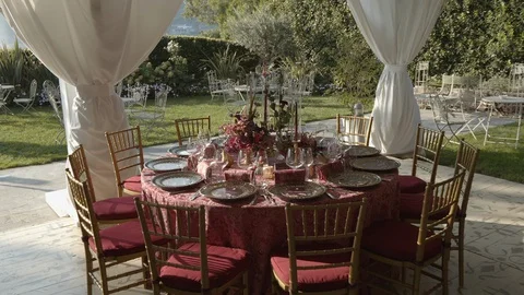 Festive table with tablecloth on which are plates, flowers, fruits, candlesticks Stock Footage 128762726