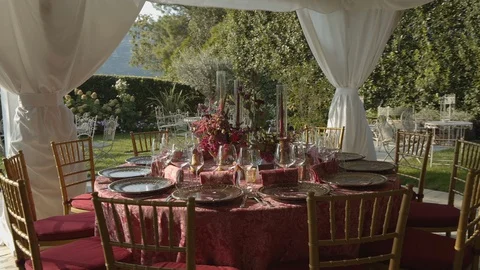 Festive table with a tablecloth on which are beautiful plates, flowers, fruits Stock Footage 128762734