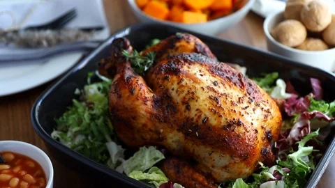 Festive table with whole roasted chicken, pumpkin and mushrooms Stock Footage 127299015