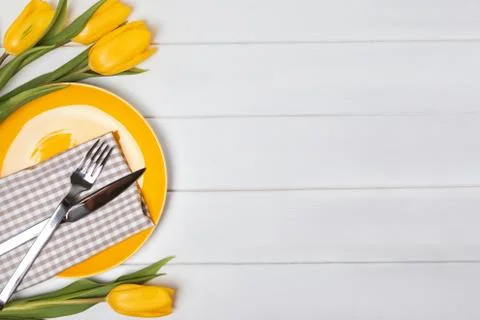 Festive table with yellow tulips. Stock Photos