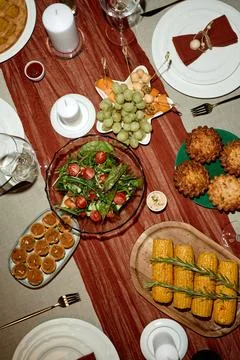 Festive Thanksgiving Dinner Table Served with Corn and Salad Stock Photos