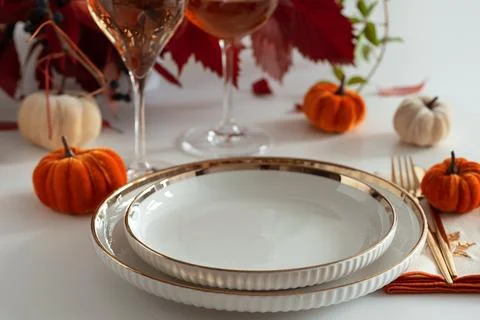 Festive Thanksgiving table setting with mini pumpkins, elegant plates, and .. Stock Photos