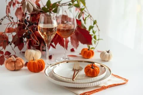 Festive Thanksgiving Table Setting with Pumpkins Wine Glasses and Autumn Fo.. Stock Photos