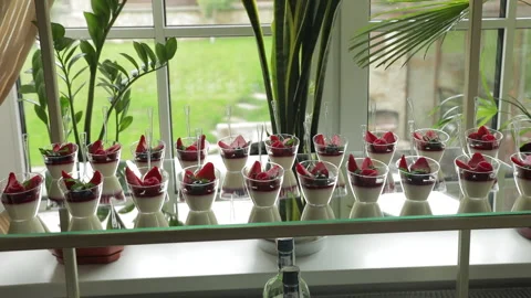 A festive transparent dessert table filled with individual strawberry panna Stock Footage 324814825